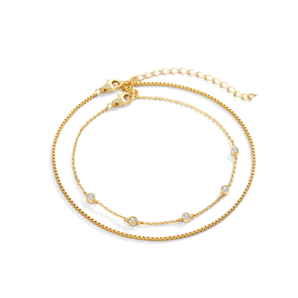 Gold bracelet with small beads on a white background