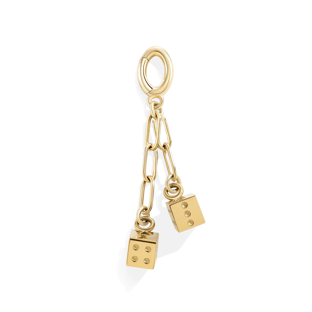 Gold charm with dice and paperclip design on a light gray background