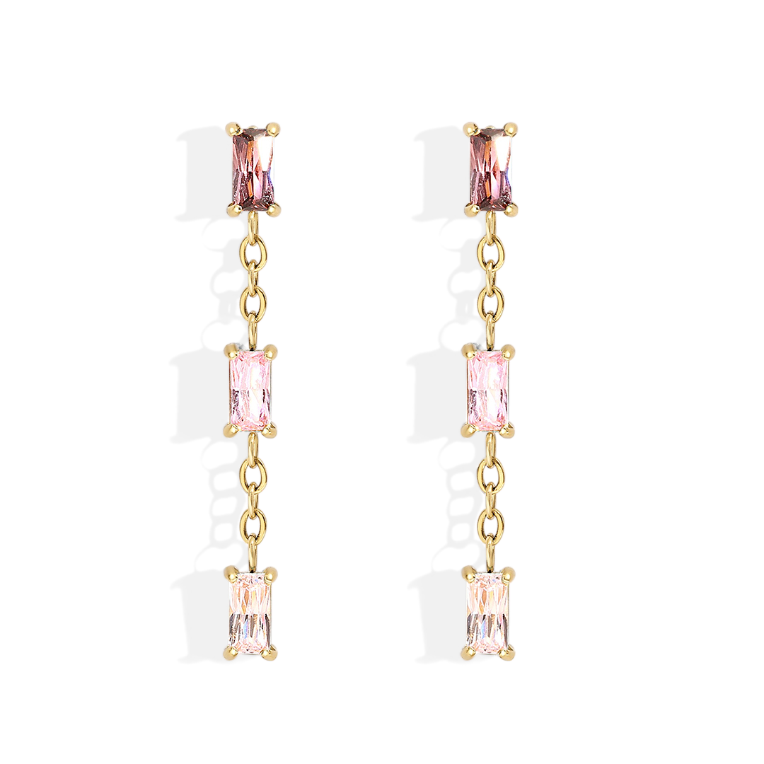 Gold earrings with pink gemstones on a light gray background