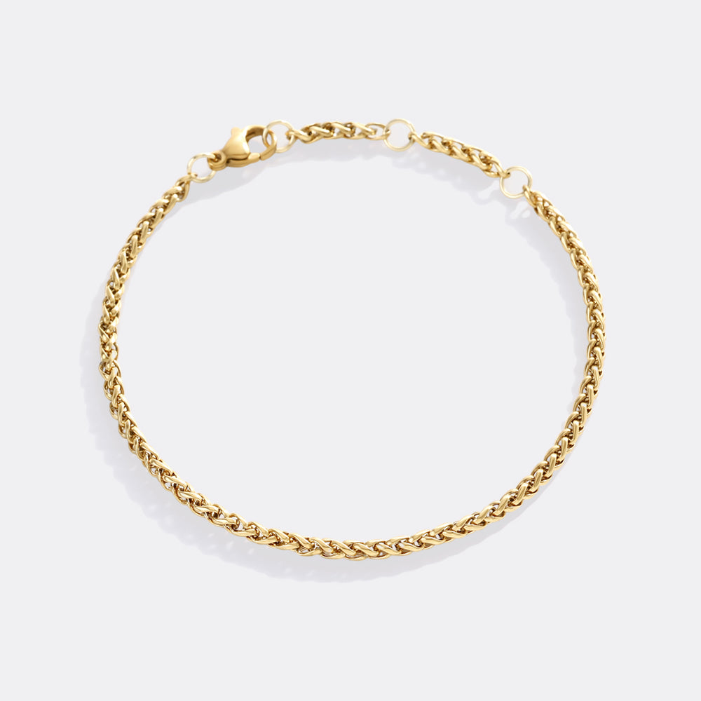 Gold chain bracelet on a white background