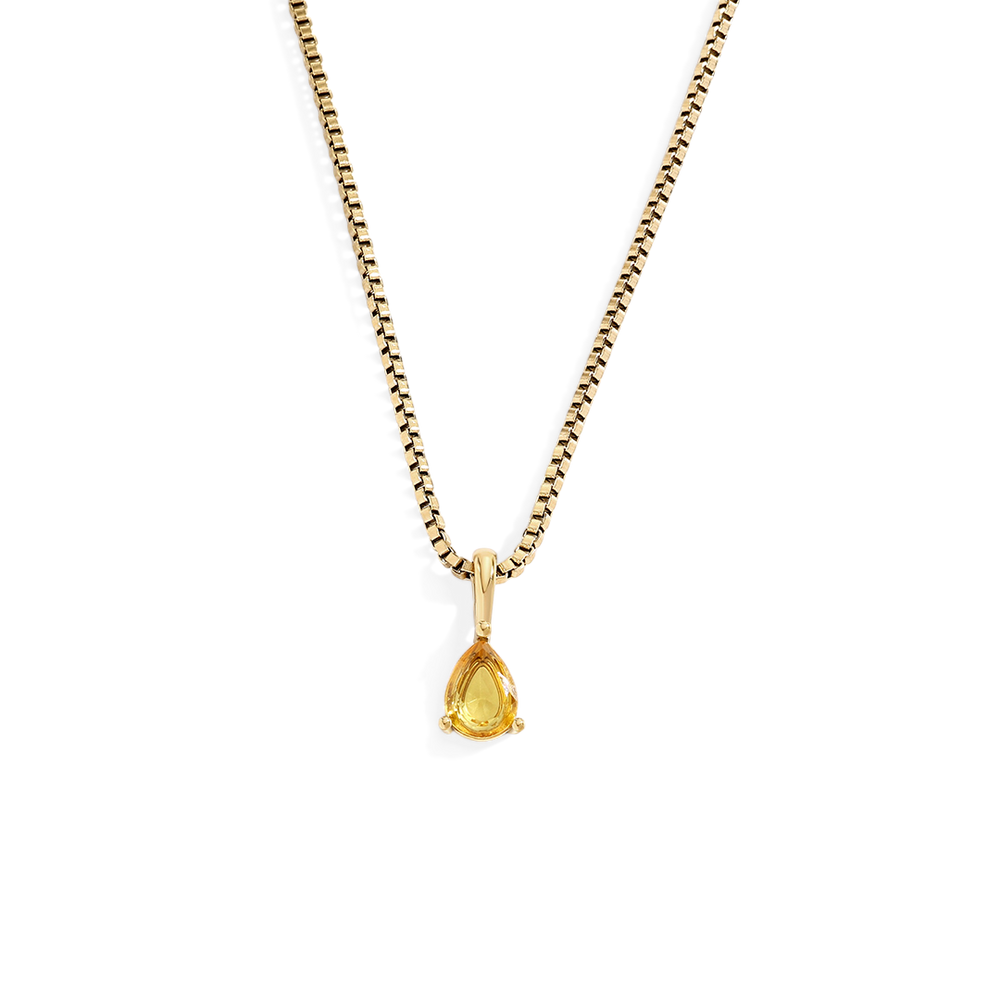 Gold necklace with a teardrop-shaped pendant on a white background