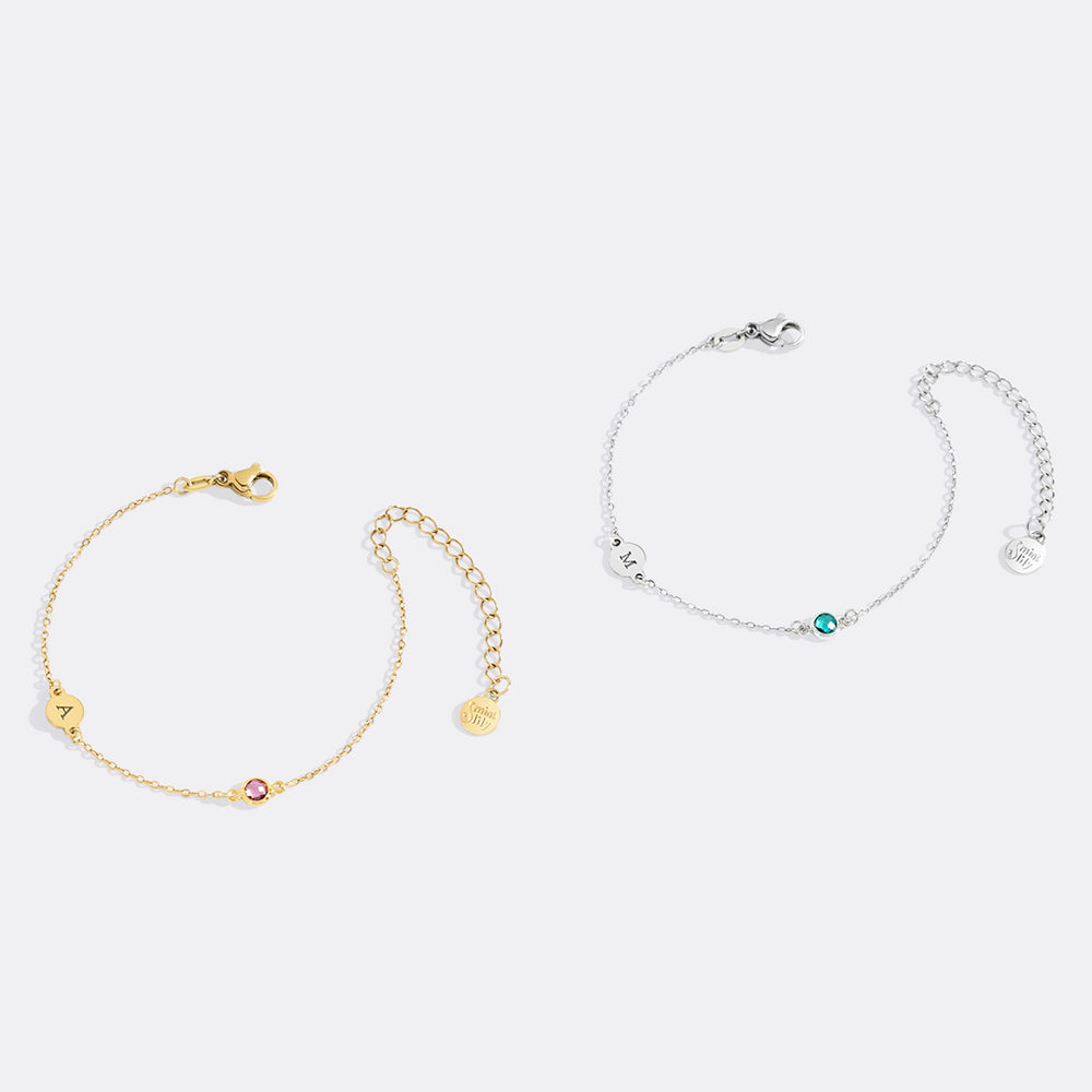 Two gold and silver bracelets on a white background