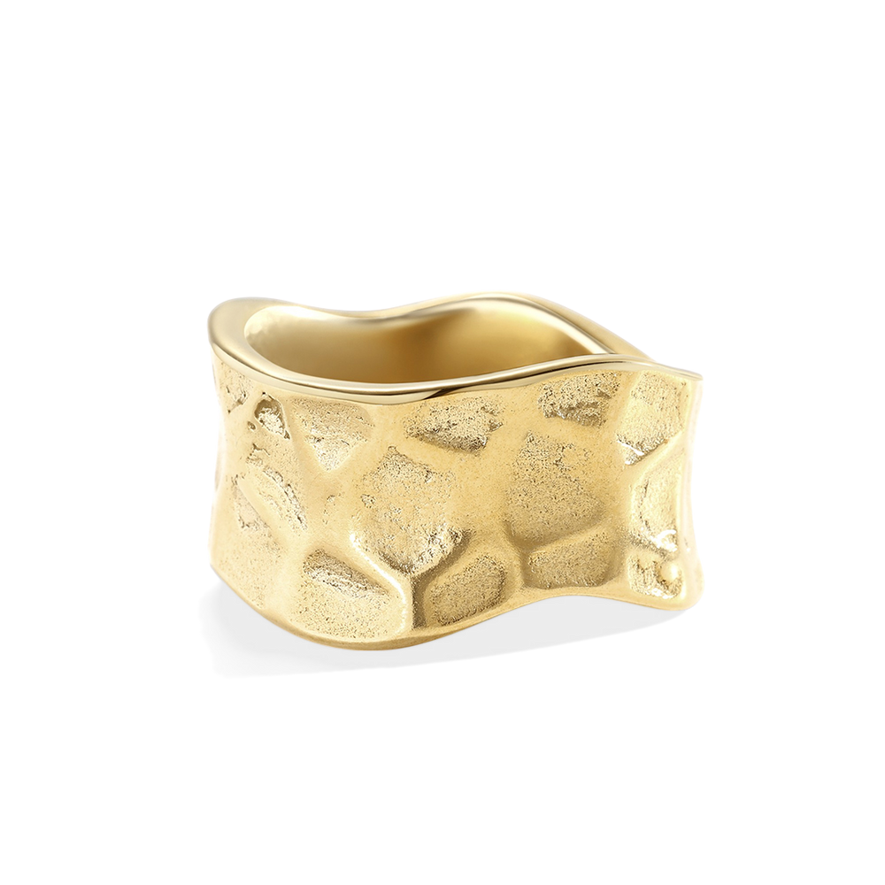 Gold ring with textured surface on a light gray background