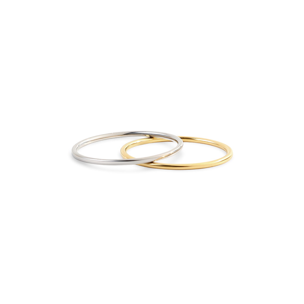 Two gold and silver bangles on a white background