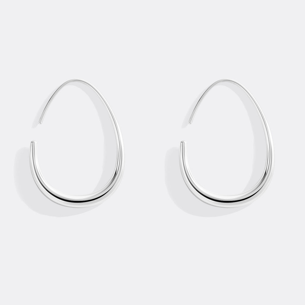 Pair of silver hoop earrings on a light gray background