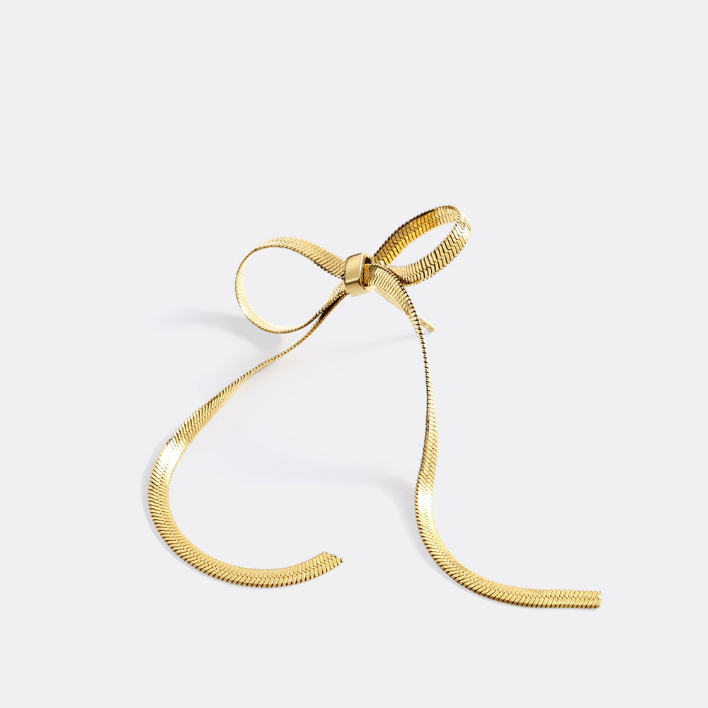 Gold bow-shaped ribbon on a light gray background