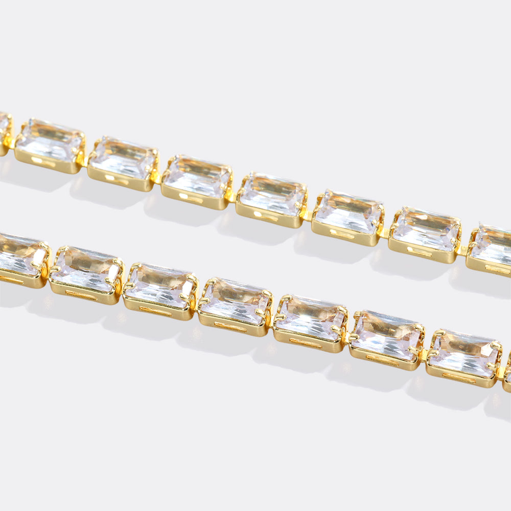 Bracelet with gold and clear gemstones on a light background