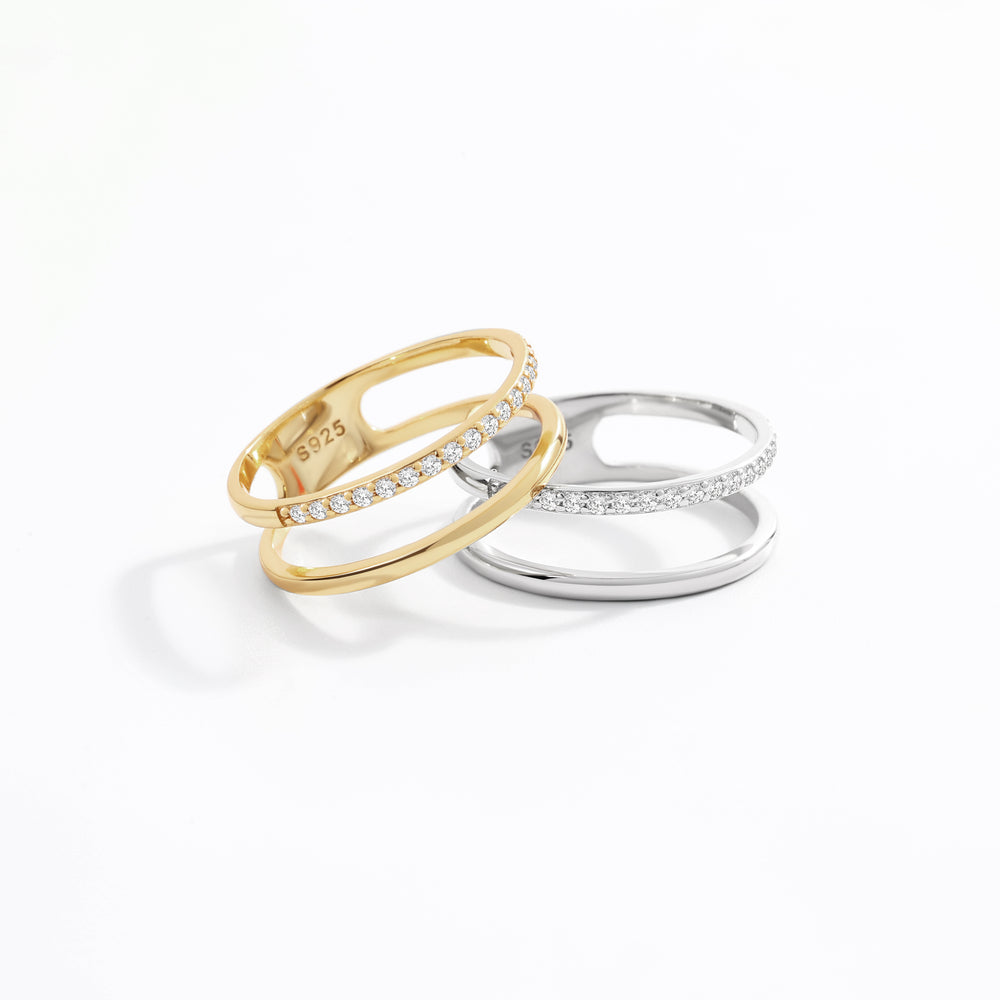 Two rings, one gold and one silver, on a white background