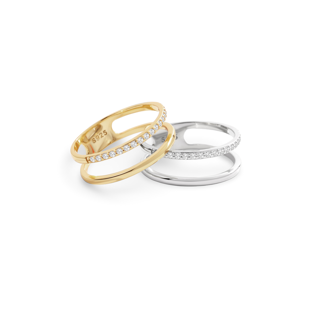 Two rings, one gold and one silver, on a white background