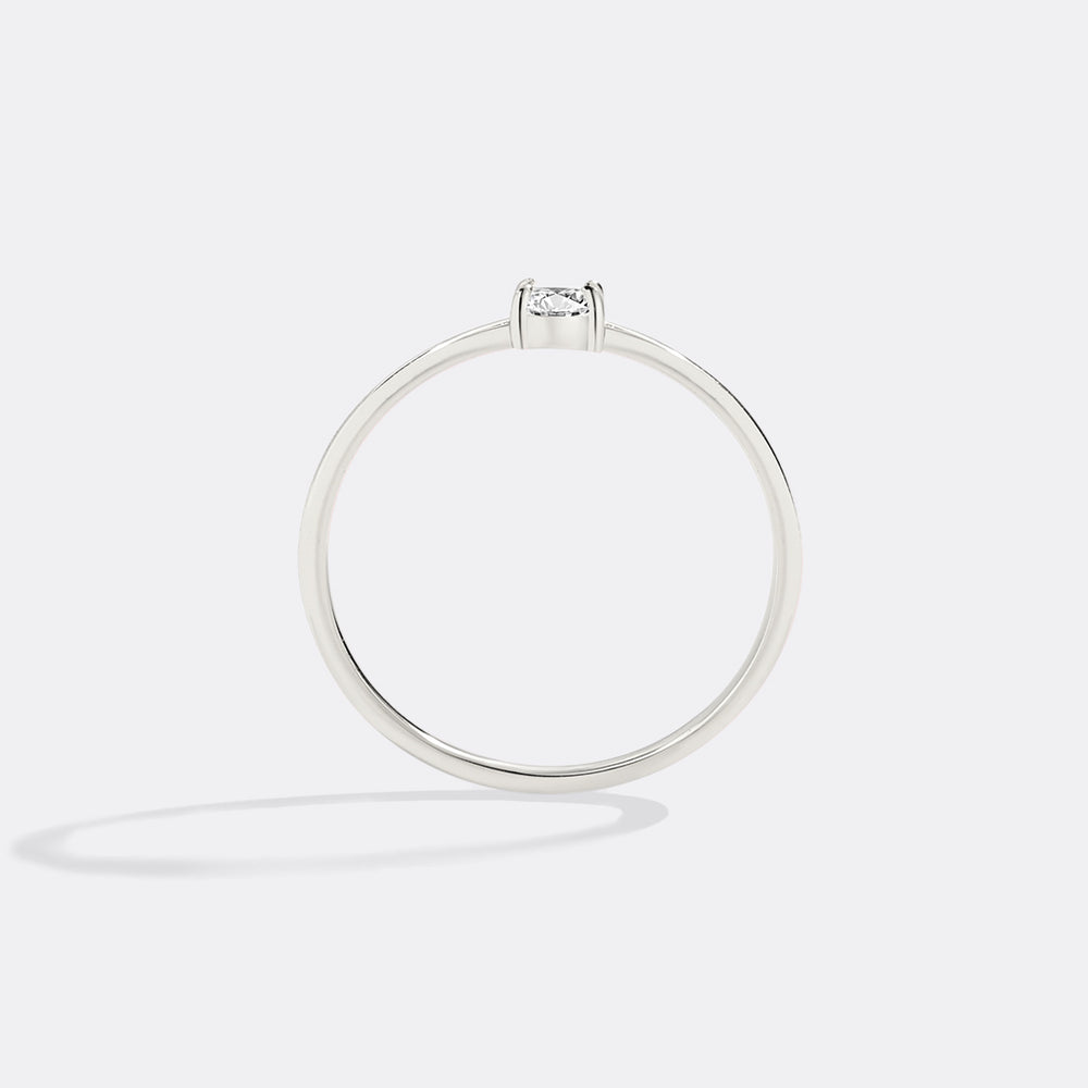 Silver ring with a diamond on a light gray background