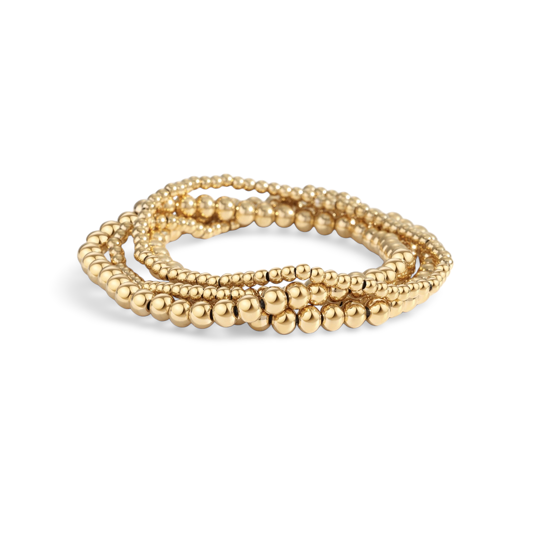 Two gold-colored beaded bracelets with a gold-filled design, displayed in a stacked arrangement.