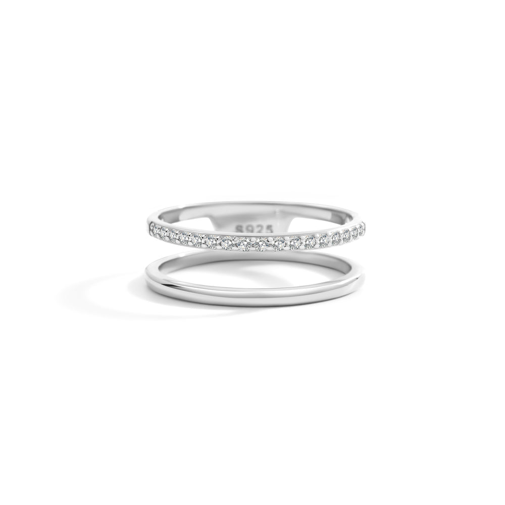 Two silver rings with small diamonds on a white background