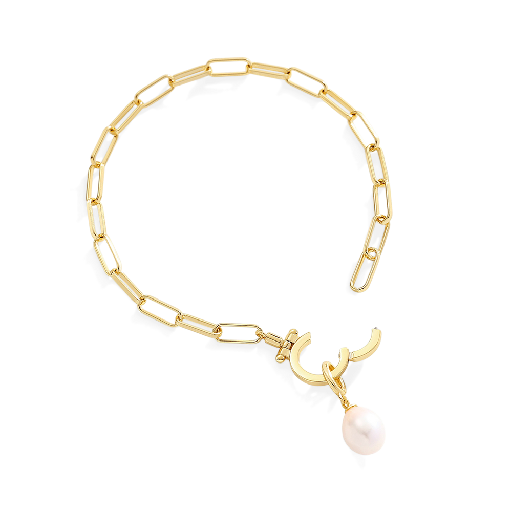 Gold bracelet with a pearl charm on a white background