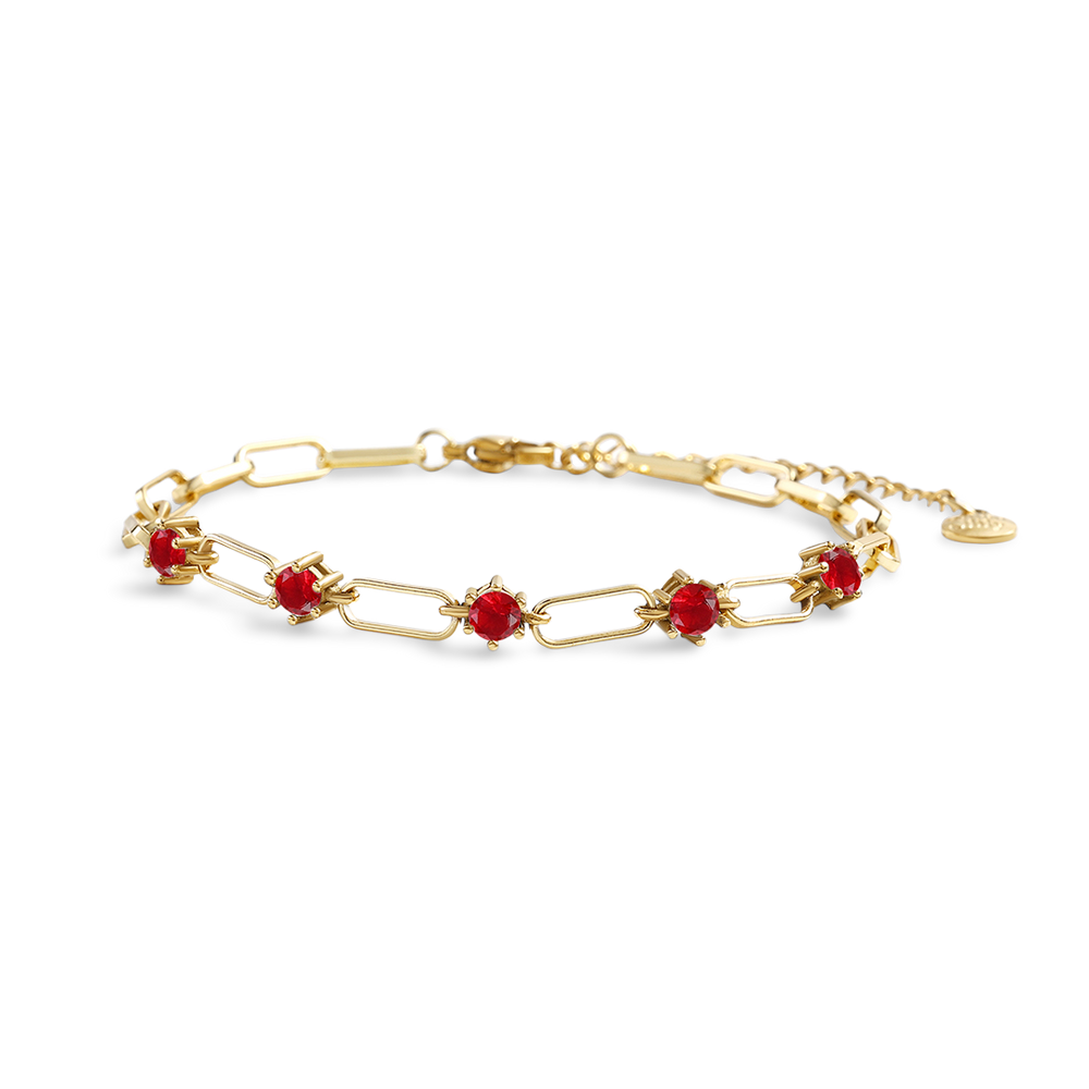 Gold bracelet with red stones on a white background