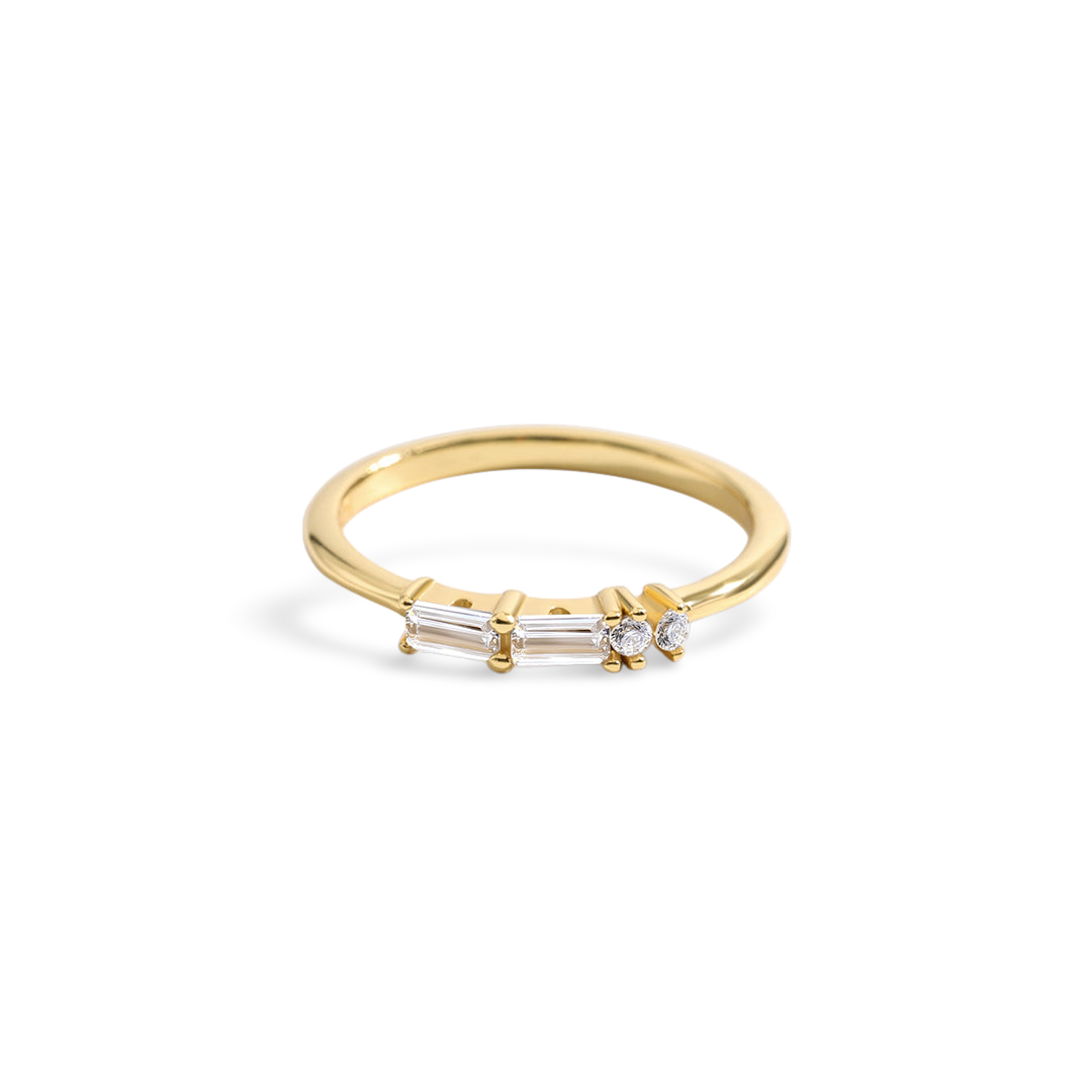 Gold ring with three diamonds on a light gray background