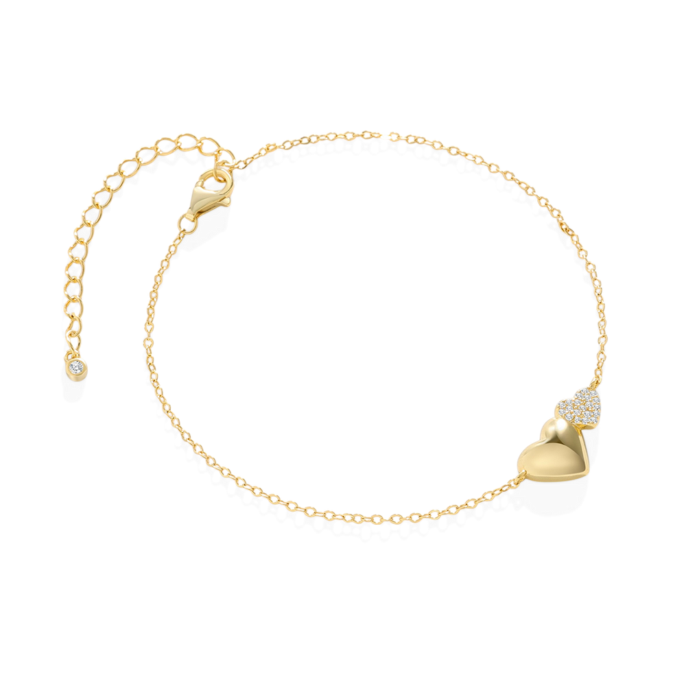 Gold bracelet with a heart-shaped clasp on a light gray background