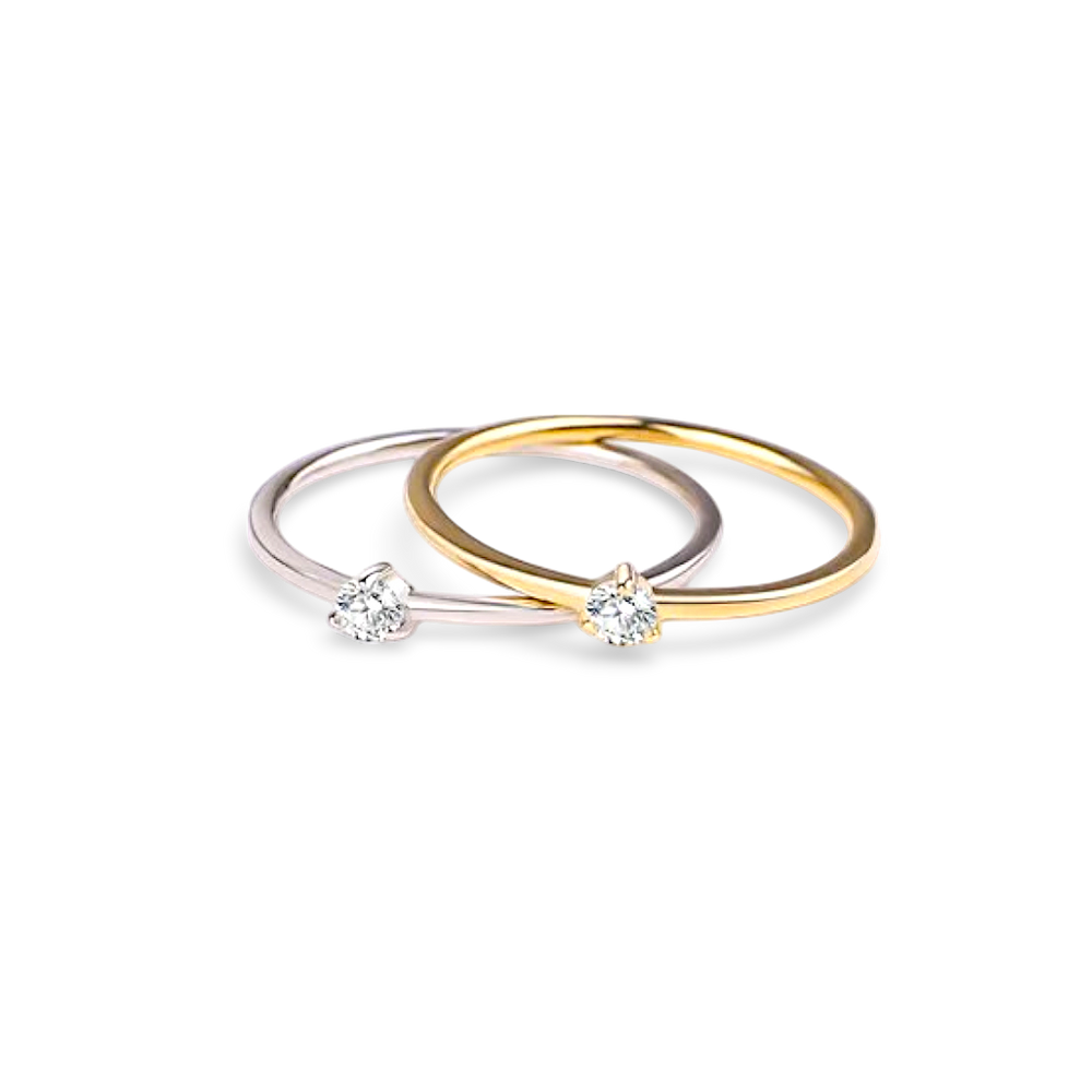 Two gold rings with embedded diamonds on a light gray background