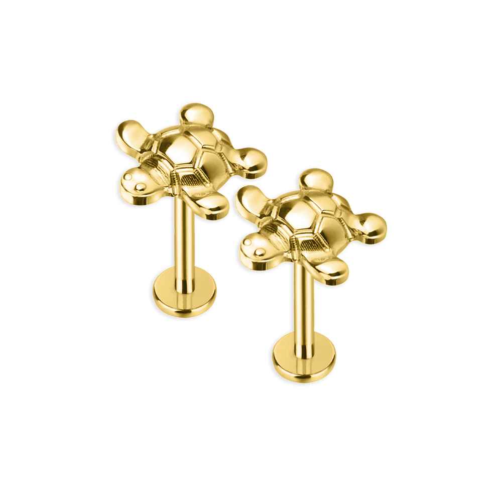 A single gold-colored labret stud with a bee design on a post.